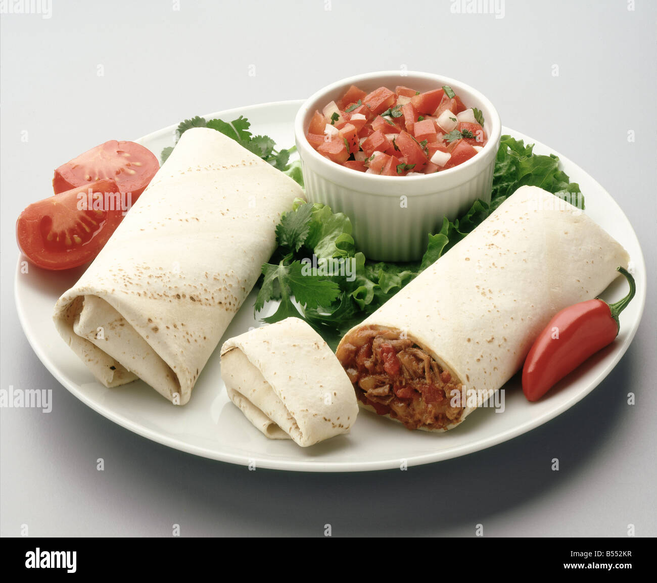 Shredded beef burrito with red salsa Stock Photo Alamy