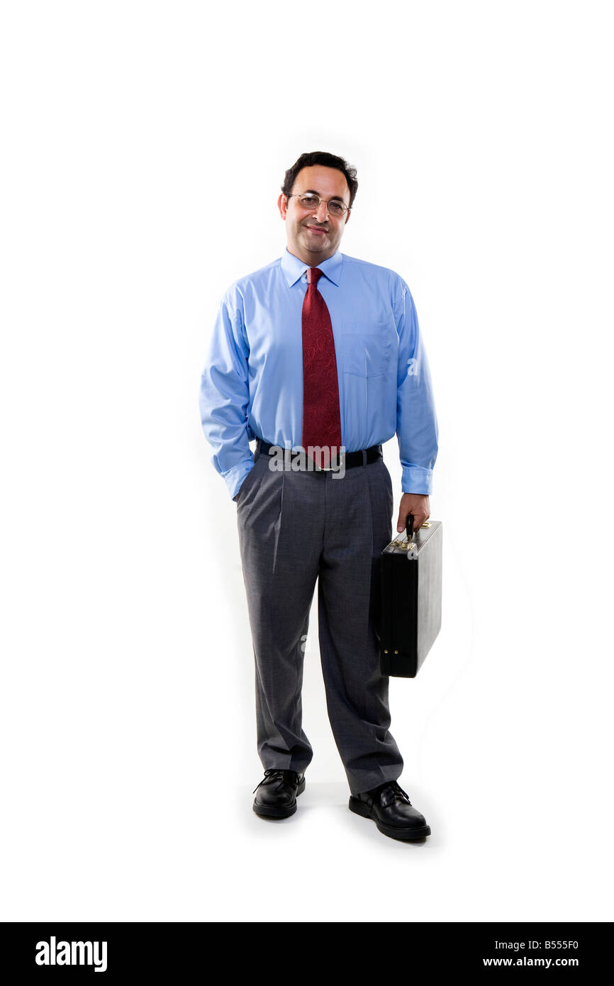 business man standing full length holding briefcase with hand in pocket Stock Photo