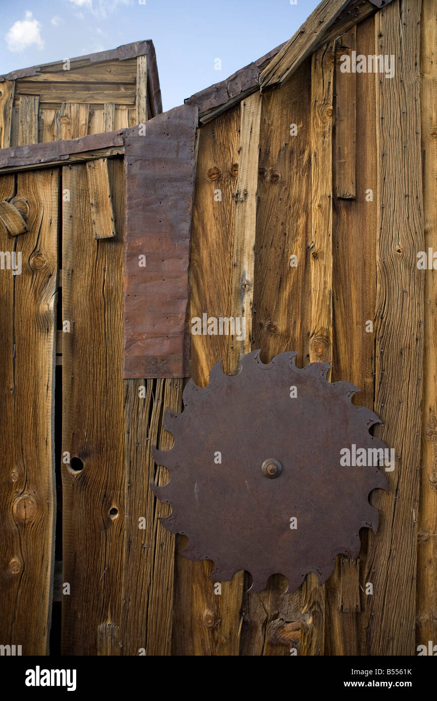 Detail of gnarled, knotted wood and section of woodsaw in Bodie Ghost Town Stock Photo