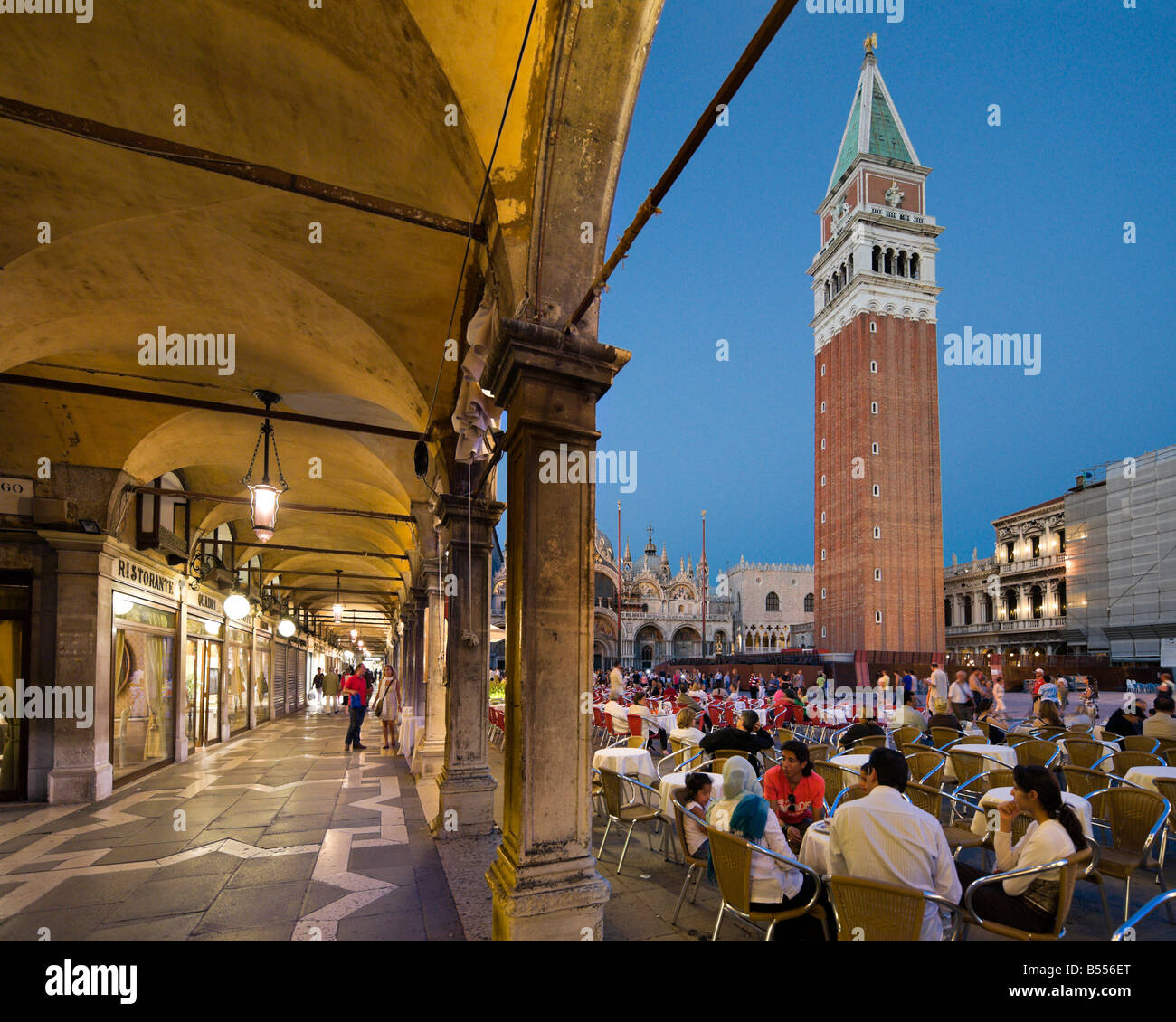 Restaurants and shops in the Piazza San Marco at night in front of the Campanile and Basilica, Venice, Veneto, Italy Stock Photo