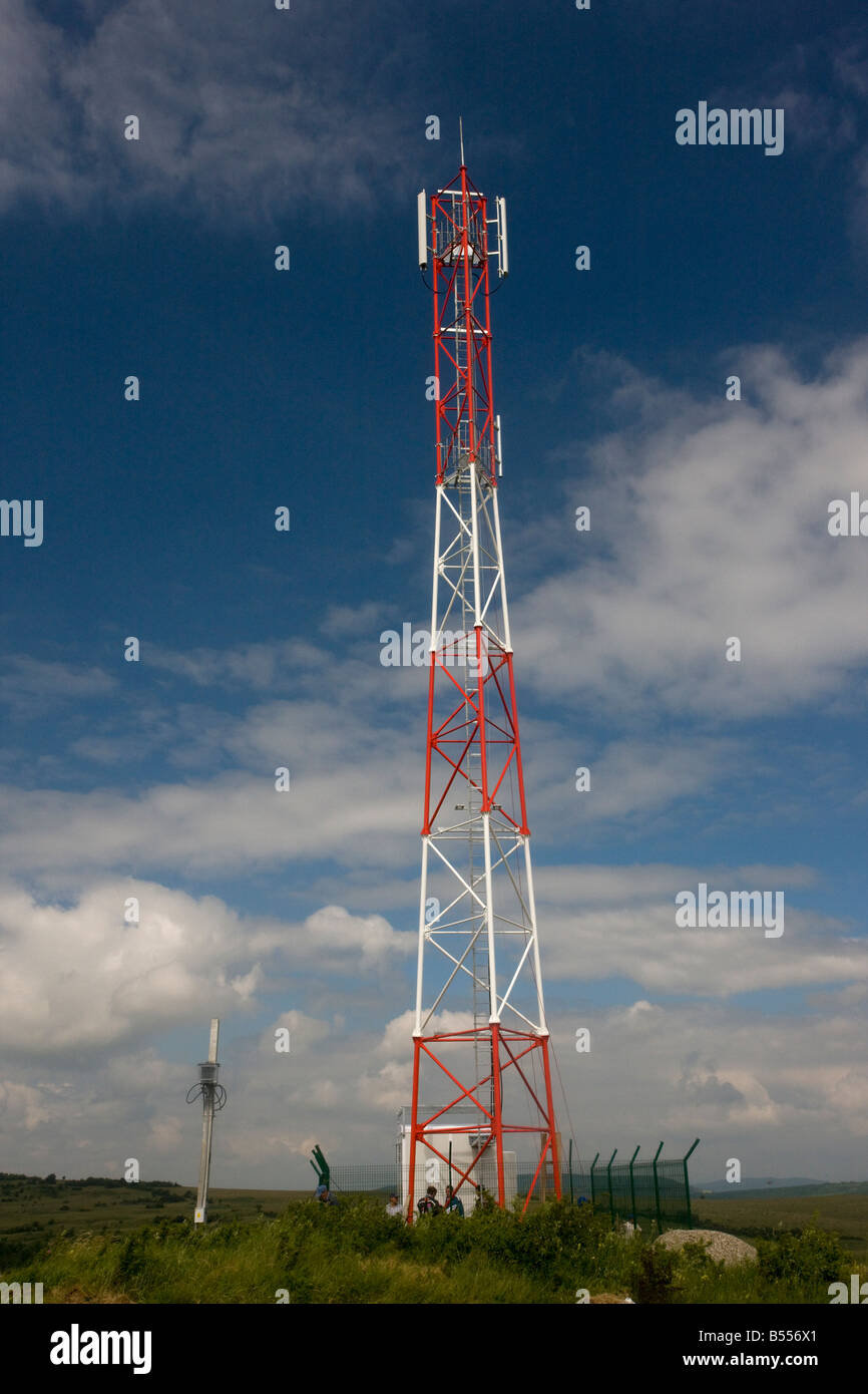 Orange mobile phone mast in flowery grasslands Transilvania Romania Stock Photo
