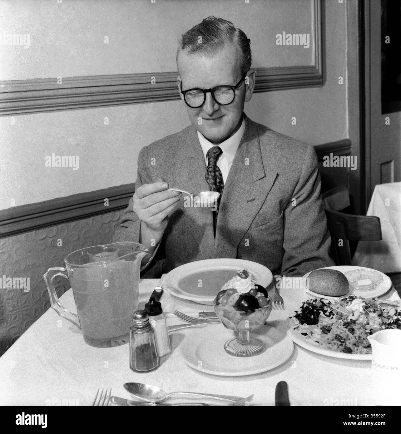 Food: Vegetarian: Mr. John Walton, eating the birthday lunch in the vegetarian restaurant in Ludgate Hill. August 1953 D5057-001 Stock Photo