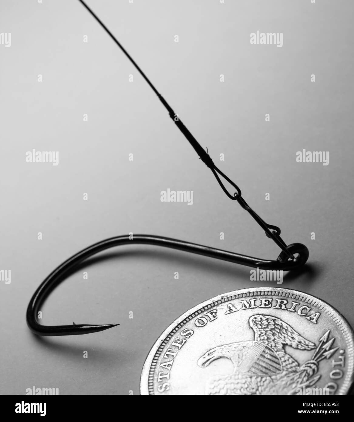 The close-up of old one dollar coin and fish hook Stock Photo
