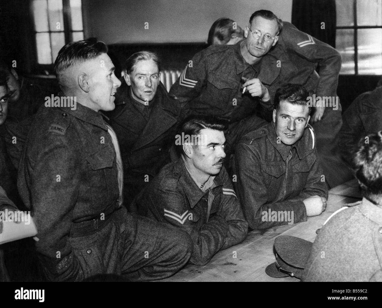 R.S.M. T.H. Bennett of Portsmouth (left of pic) with some of the 16 repatriated prisoners - swapping experiences of life in Italian prison camps. June 1942 P011643 Stock Photo