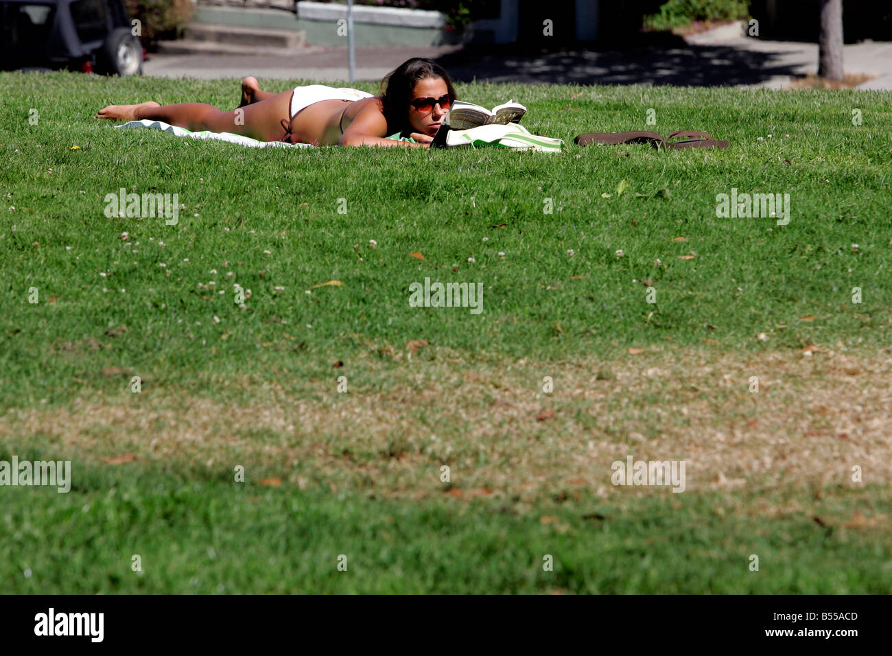 US SAN FRANCISCO a girl sunbathing on Alamo Square PHOTO GERRIT DE HEUS Stock Photo