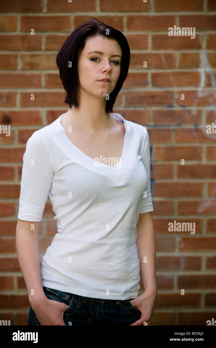 16 Year Old Teenage Teen Girl Young Woman Standing In Front Of Brick Wall Stock Photo Alamy