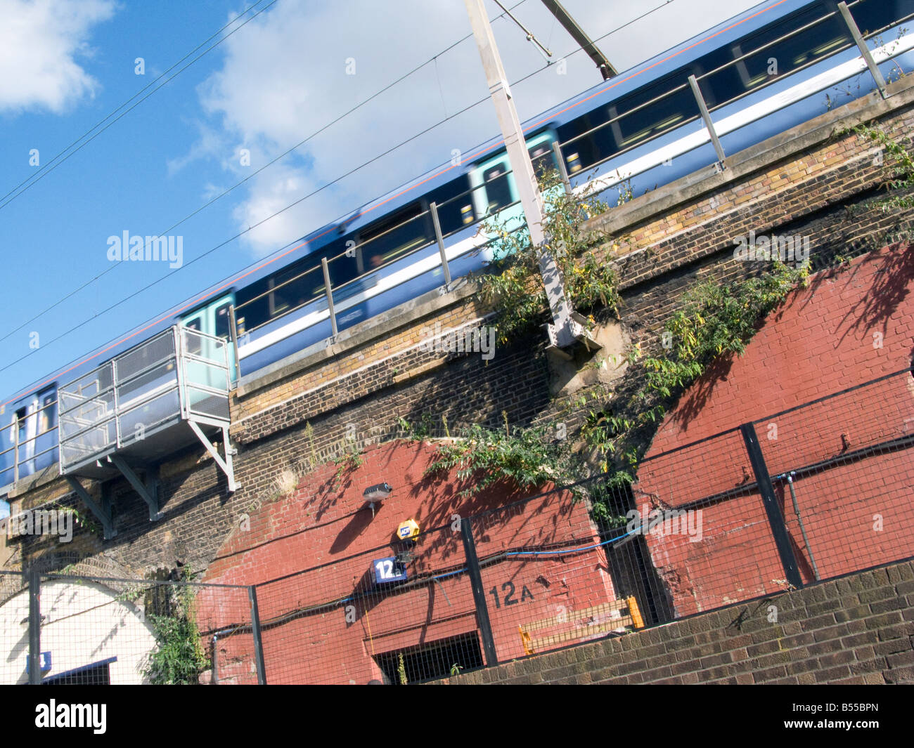 UK-Suburban train over bridge in Bethnal Green Rd, London.Photo © Julio Etchart Stock Photo