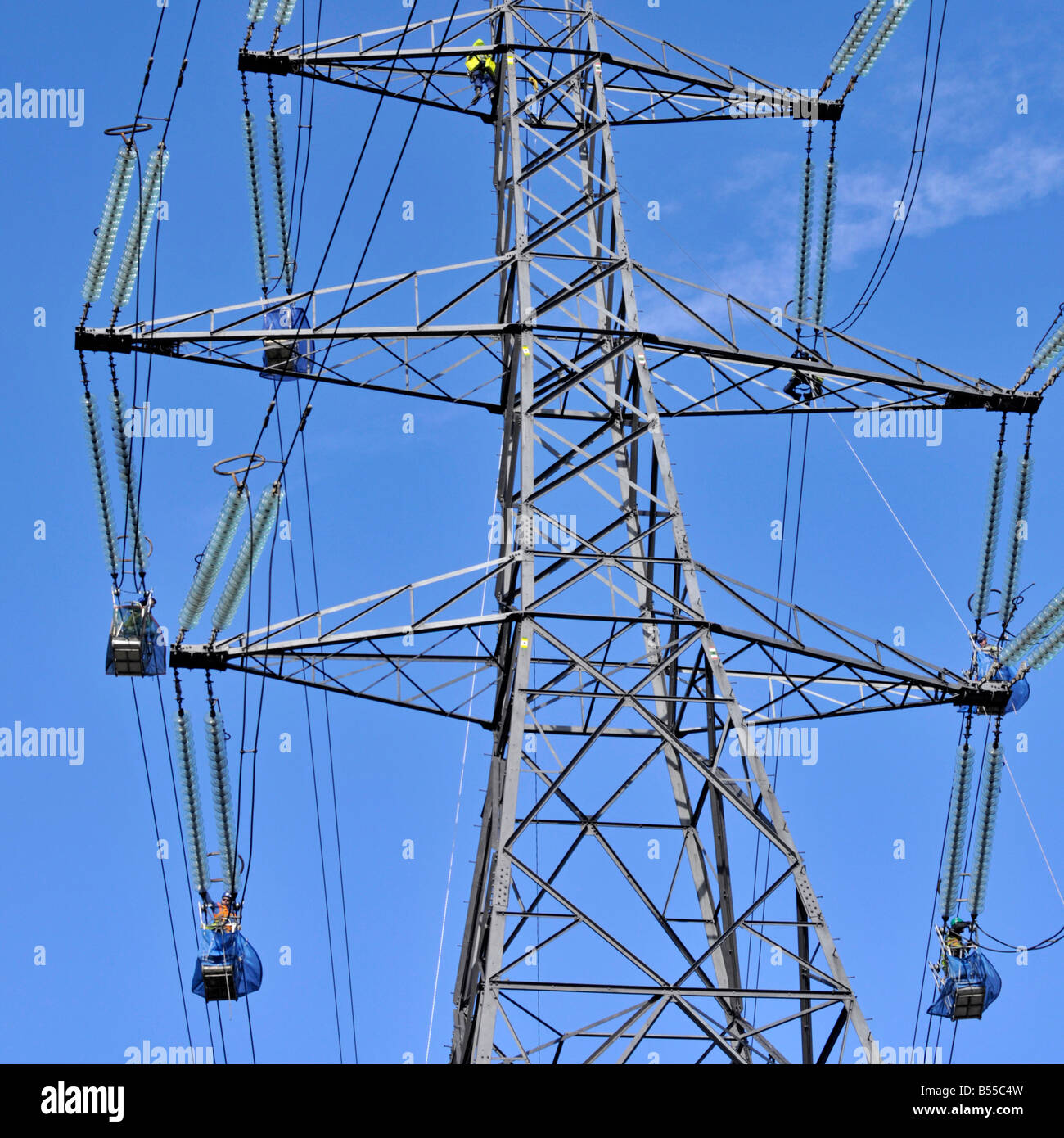 Engineers working on overhead power lines Stock Photo