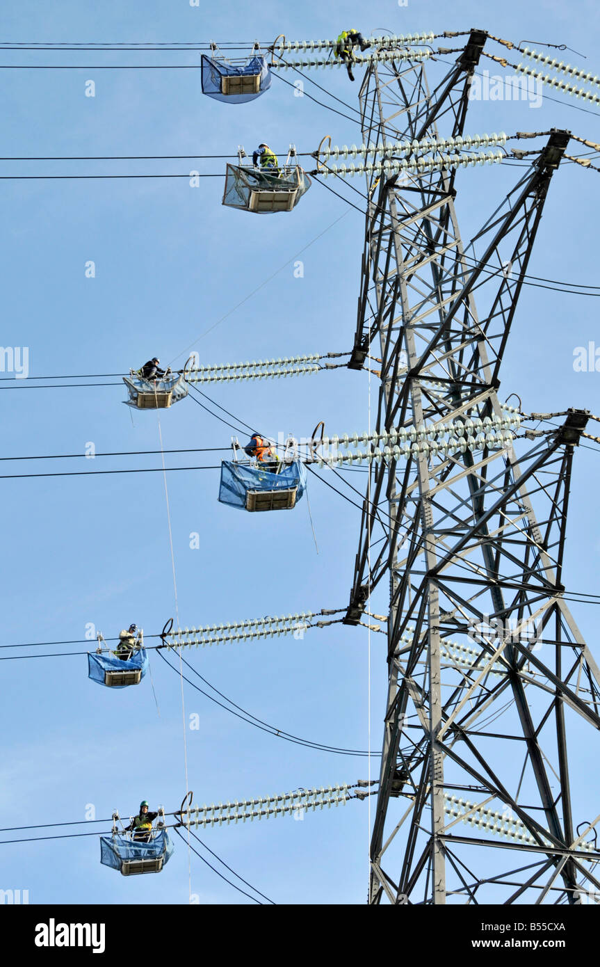 Engineers working on overhead power lines Stock Photo