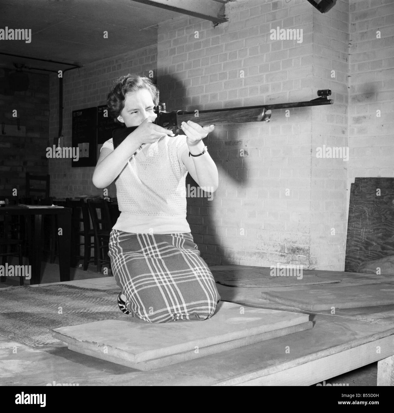 Woman with Rifle: Miss Mavis Felmingham, 17, the 'Annie Oakley' of the Sentinal Engineering works at Shrewsbury. Five months ago Mavis, a clerical worker, had never handled a gun. She has just won the Works Coronation Shield competed for by 53 members of the Rifle Club, including seasone County Championship contestants. She has now been selected to shoot in the works team which competes in the Shropshire League. October 1953 D6232 Stock Photo