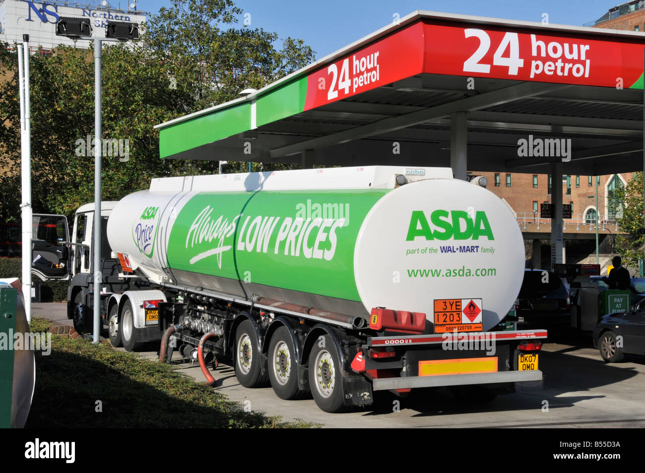 Asda supermarket  24 hour petrol filling station hgv lorry truck & articulated delivery tanker trailer unloading to forecourt Crossharbour London UK Stock Photo