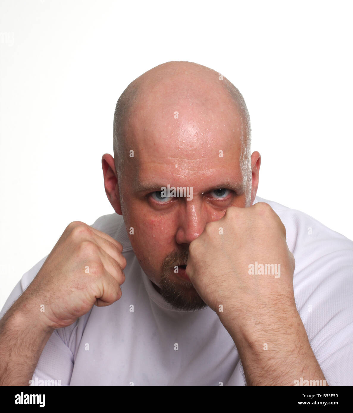 A grim faced man in a fighting position Stock Photo