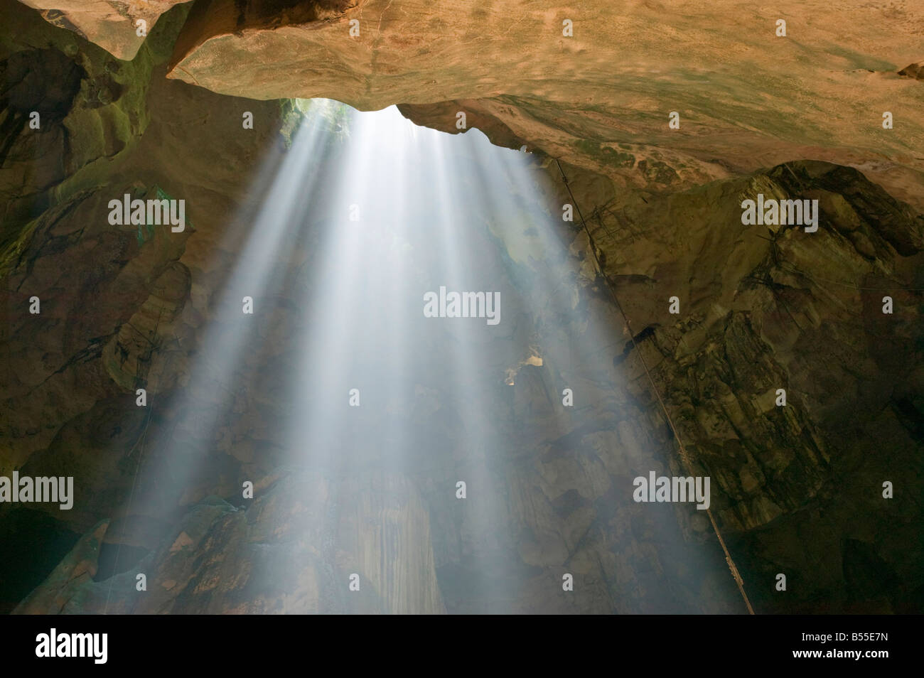 Light pouring into the Great Cave through a sink hole in its roof Niah National Park nr Miri Sarawak Malaysia Stock Photo