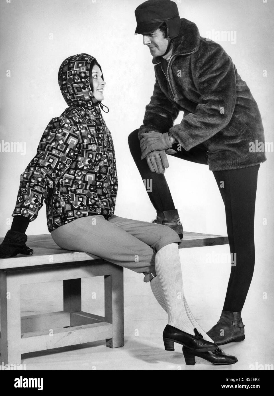 Her yellow stretch knicker-bockers, orange, black and olive anorak with quilted lining;His fur-look coat, ski pants and furry-lined cap ;January 1969 ;P008546 Stock Photo