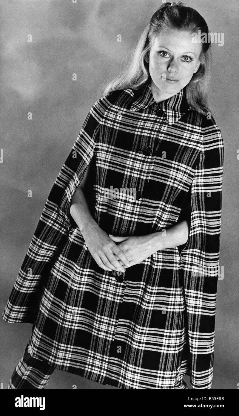 Scotch on the rocks. For girls who like their tartans neat, Burberry's reversible cape stays in good shape when the weather is at its worst. It is waterproof and has zip-up hand slits to keep out rain and wind on blustery days. In a choice of tartans from branches of the Scotch House. ;October 1969 P008558 Stock Photo