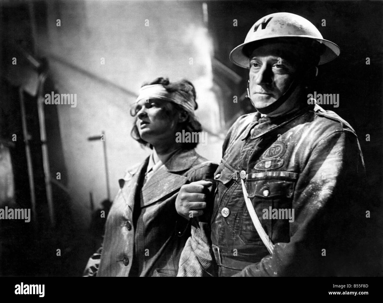 Air Warden Percy Dale helping bomb victim circa 1944. P009207 Stock Photo