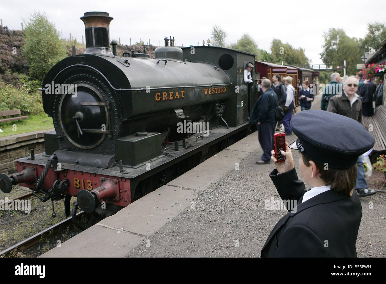 A young volunteer captures the historic moment on his mobile of Locomotive No 813 being put through its paces at Tanfield Railway for the Legends of Industry Gala weekend Stock Photo