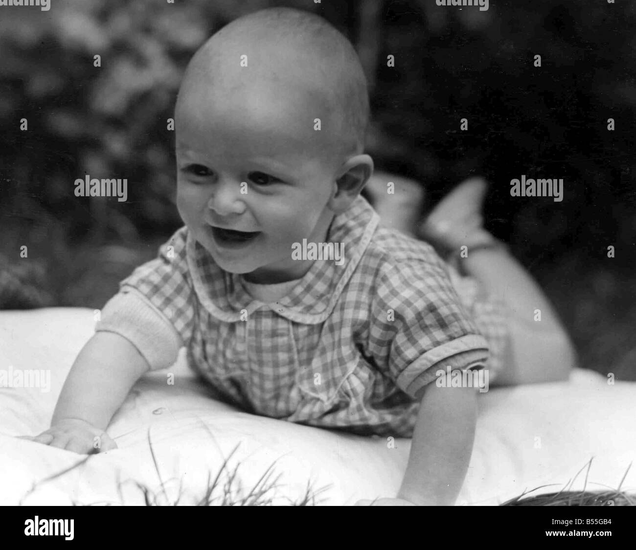 Young baby crawling around on the mat in the back garden Circa 1945