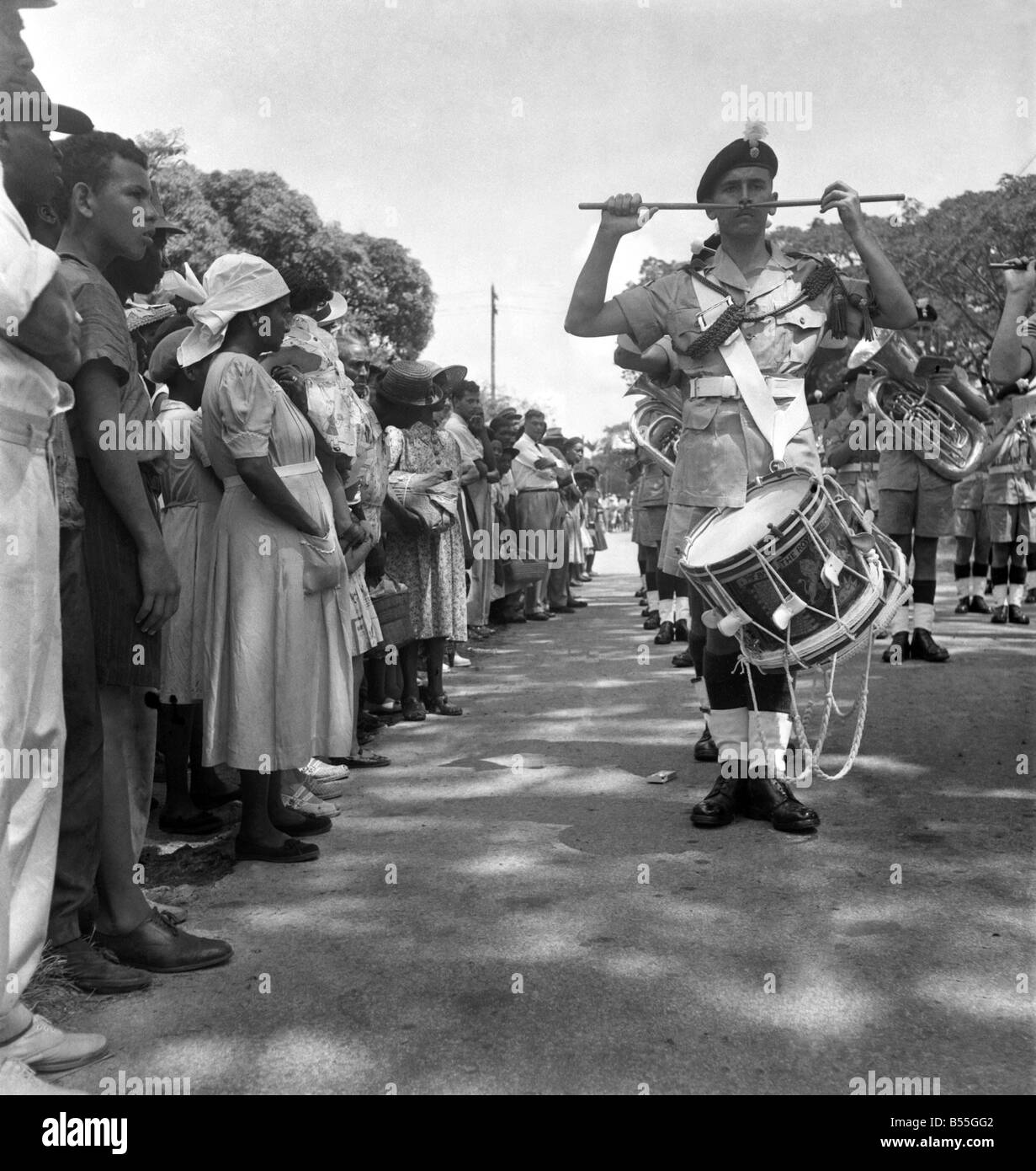 British soldiers marching in British Guiana watched by local citizens. The troops