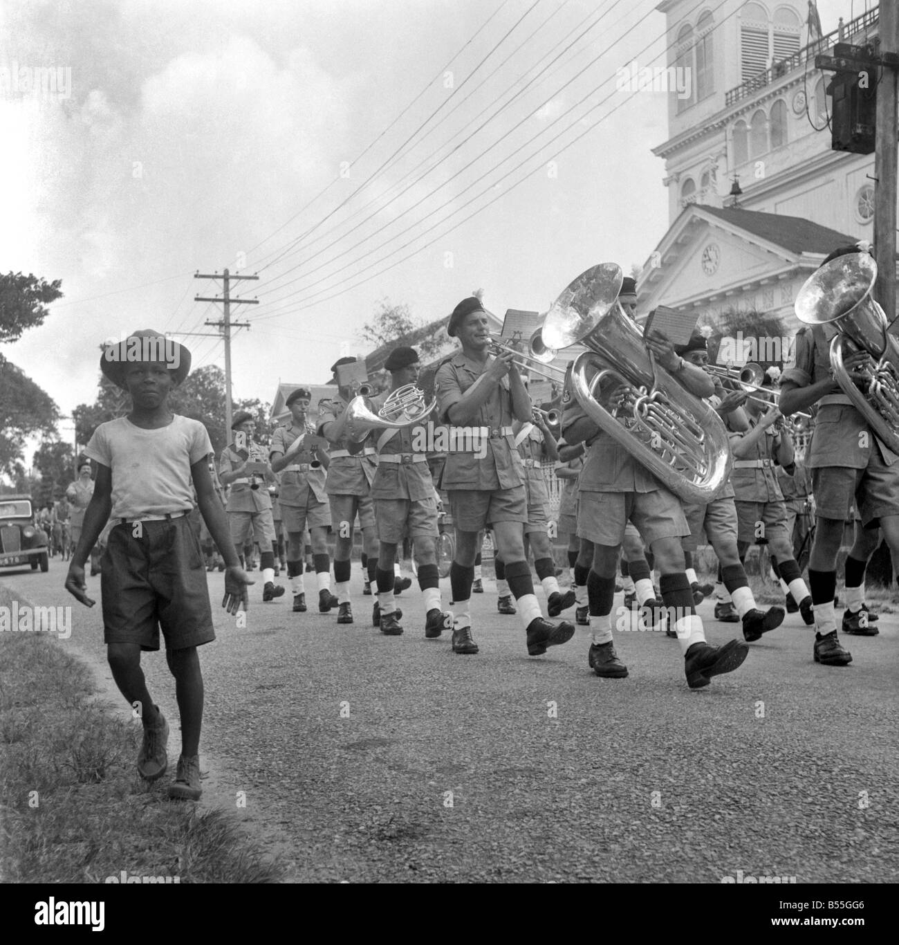 British soldiers marching in British Guiana watched by local citizens. The troops