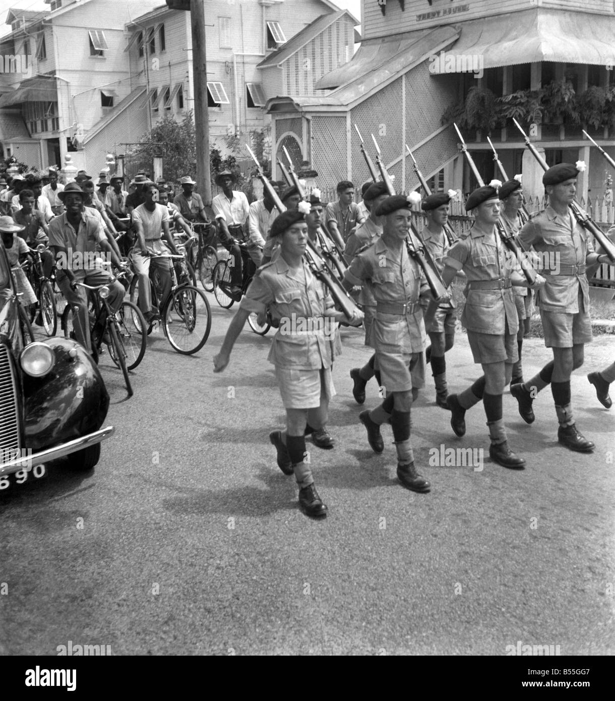 British soldiers marching in Georgetown, British Guiana watched by local citizens. The troops were sent to calm a serious constitutional crisis whaich arose following the election earlier in the year. ;October 1953 ;D6229-005 Stock Photo