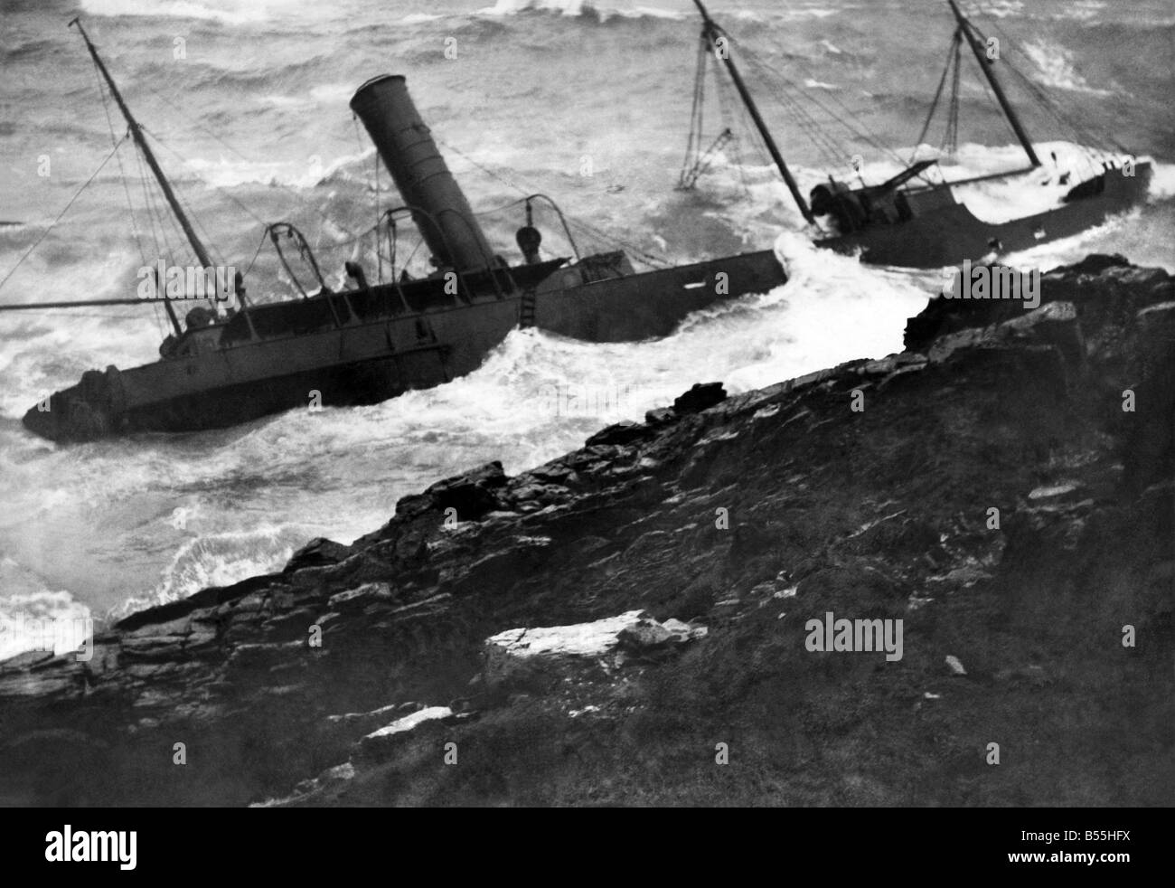 While on her way to Belfast with coal, the Belfast steamer Glendun went on the rocks off the Isle of Man. A Manx farmer heard the distress signals and gave the alarm. The crew of 10 and their pet dog, Nellie, escaped in the ship's lifeboats and were picked up. The Glendun now held on the rocks, is being mercilessly pounded by the heavy seas and she is rapidly breaking up. Her cargo and engines have been washed out of her and all that remains is the hull. February 1940 P012341 Stock Photo