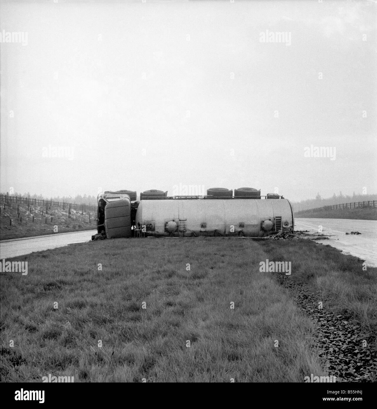 Transport Road Accidents: Tanker overturned on A18 Scunthorpe. Safety officers check the load of Acrylonitrite-highly polluted funes. December 1969 Z11901-001 Stock Photo