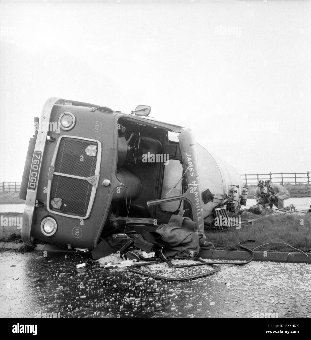 Transport Road Accidents: Tanker overturned on A18 Scunthorpe. Safety officers check the load of Acrylonitrite-highly polluted funes. December 1969 Z11901-002 Stock Photo