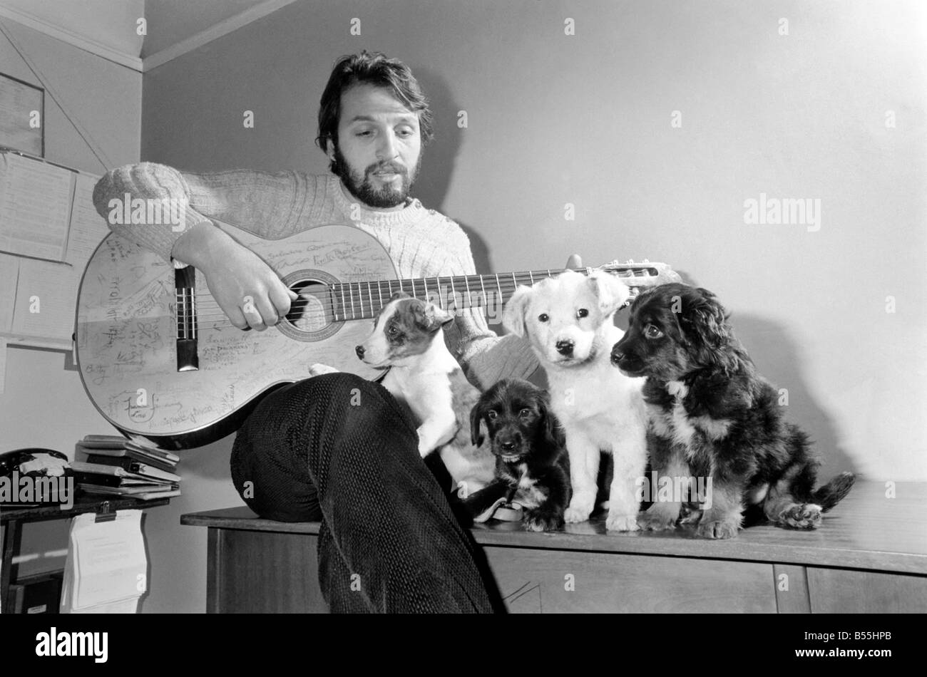 Salvatore Sangiorgi Italian singer and guitarist seen here at the RSPCA Home and Clinic Trenmare Gardens, London, singing to a pair of abandoned dogs December 1969 Z11924-001 Stock Photo