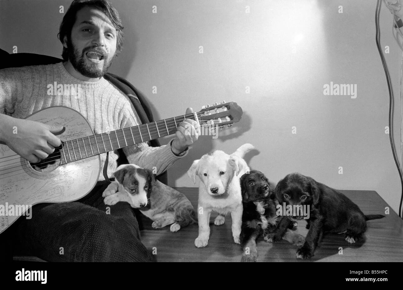 Salvatore Sangiorgi Italian singer and guitarist seen here at the RSPCA Home and Clinic Trenmare Gardens, London, singing to a pair of abandoned dogs December 1969 Z11924-002 Stock Photo