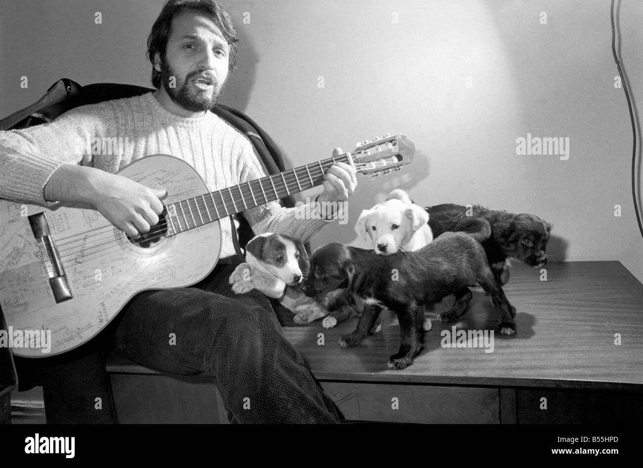 Salvatore Sangiorgi Italian singer and guitarist seen here at the RSPCA Home and Clinic Trenmare Gardens, London, singing to a pair of abandoned dogs December 1969 Z11924-003 Stock Photo