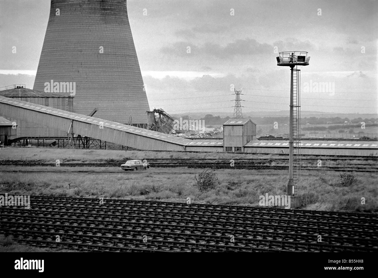 Cooling Tower: Industry: Pollution. The Cooling Tower at Ince Power station at Elston, Ellesmere Port, Cheshire goes up with a bang and a cloud of dust. November 1969 Z12012-003 Stock Photo