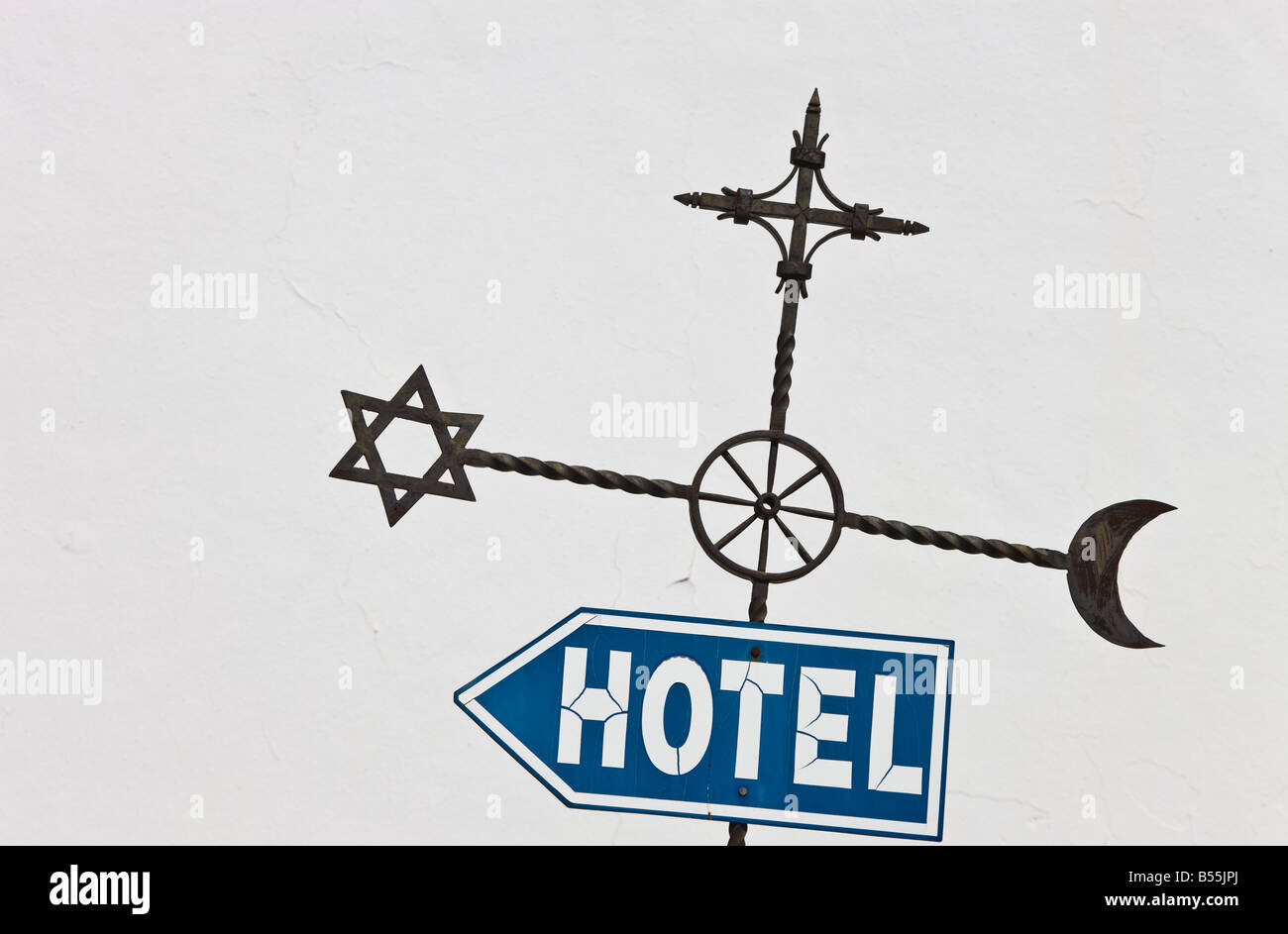 Ronda Malaga Province Spain Street sign with Islamic Jewish and Christian symbols which echo city history pointing towards hotel Stock Photo