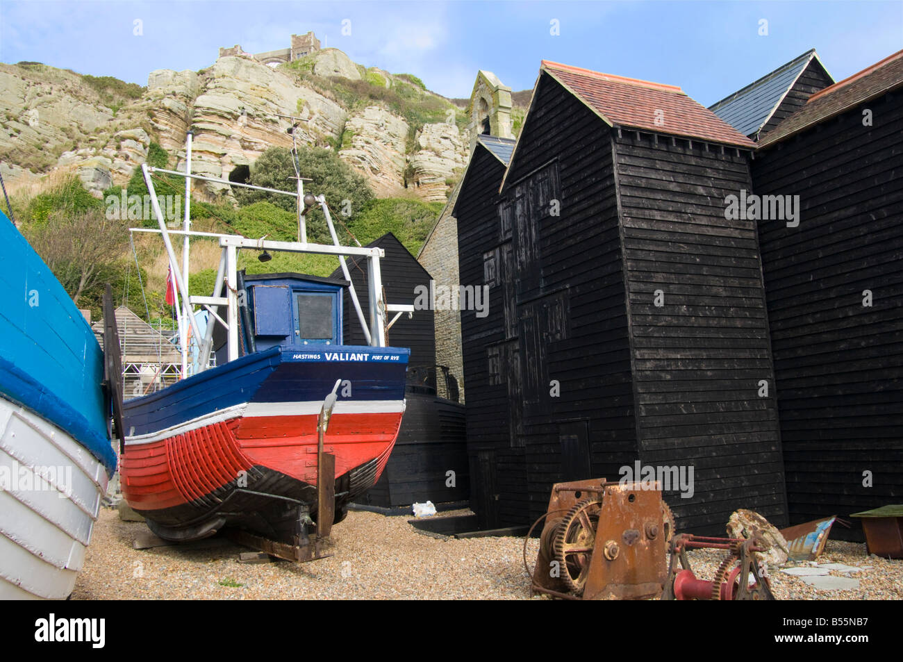Hastings, East Sussex, England, UK. Fishing boats among Shops