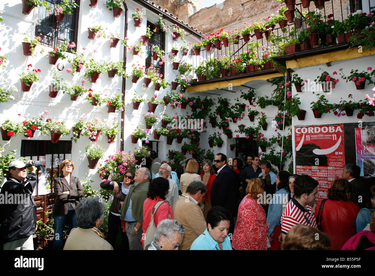 A large crowd of people inside a courtyard house as part of Los Patios, Festival of Patios in Cordoba, Spain Stock Photo