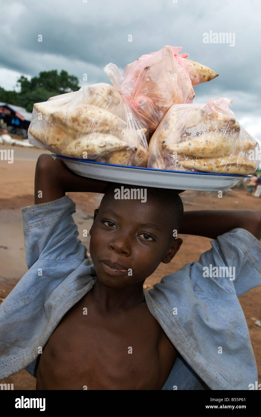 Sierra Leone road Makeni to Freetown. Ibrahim, young boy , selling potatoes Stock Photo