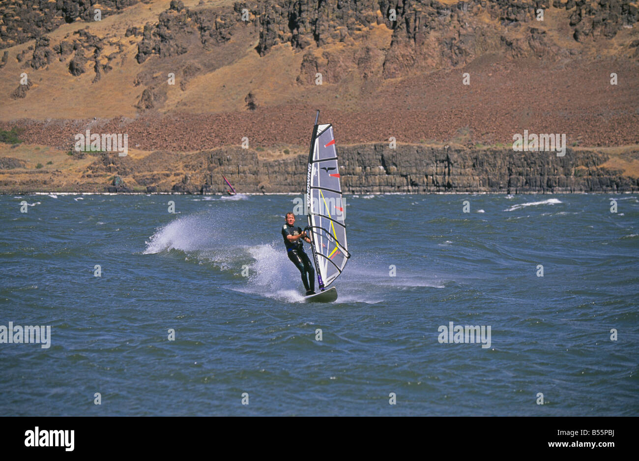 A windsurfer glides across the Columbia River near Hood River, Oregon