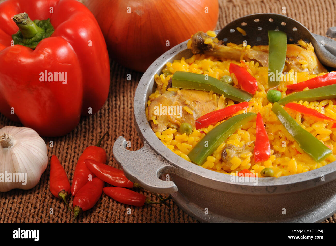 Setting with typical cuban dish - salted rice with chicken - and ingredients Stock Photo