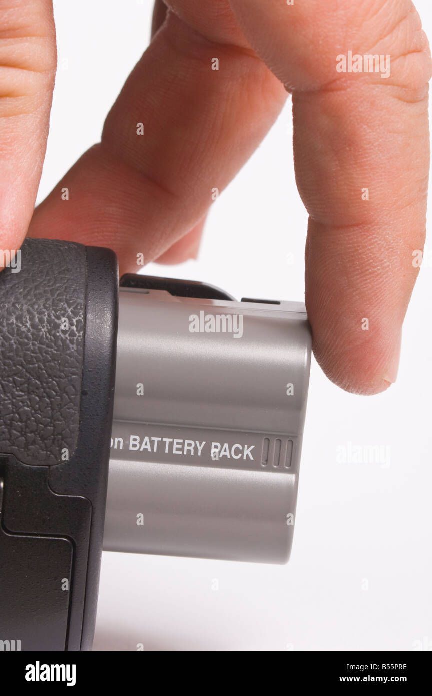 Re-chargeable digital camera battery (Li-ion) for dslr on white background being inserted inside camera Stock Photo