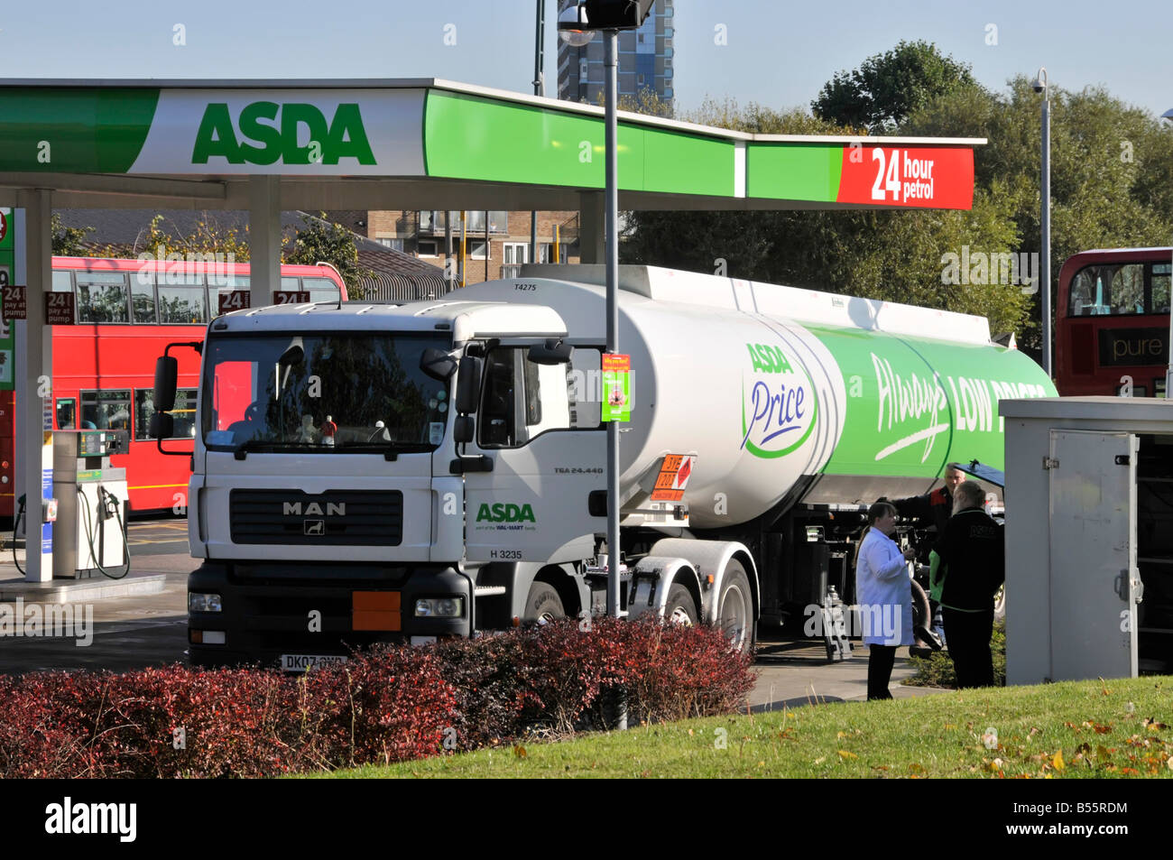 Asda supermarket  24 hour petrol filling station hgv lorry truck & articulated delivery tanker trailer unloading to forecourt Crossharbour London UK Stock Photo