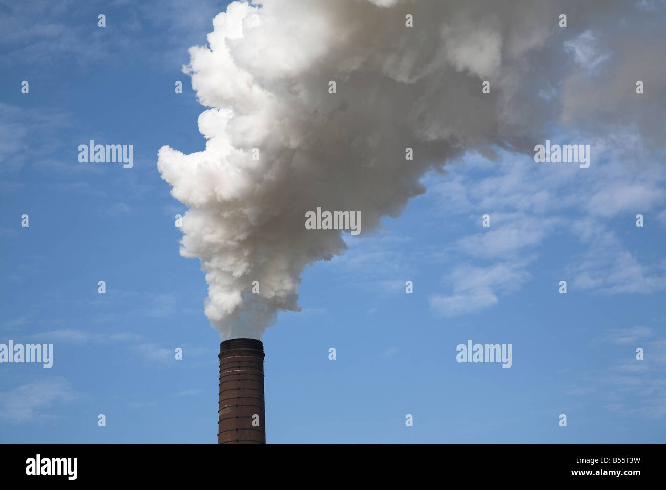 Steam smoke rising from chimney of sugar beet factory Bury St Edmunds Suffolk England Stock Photo
