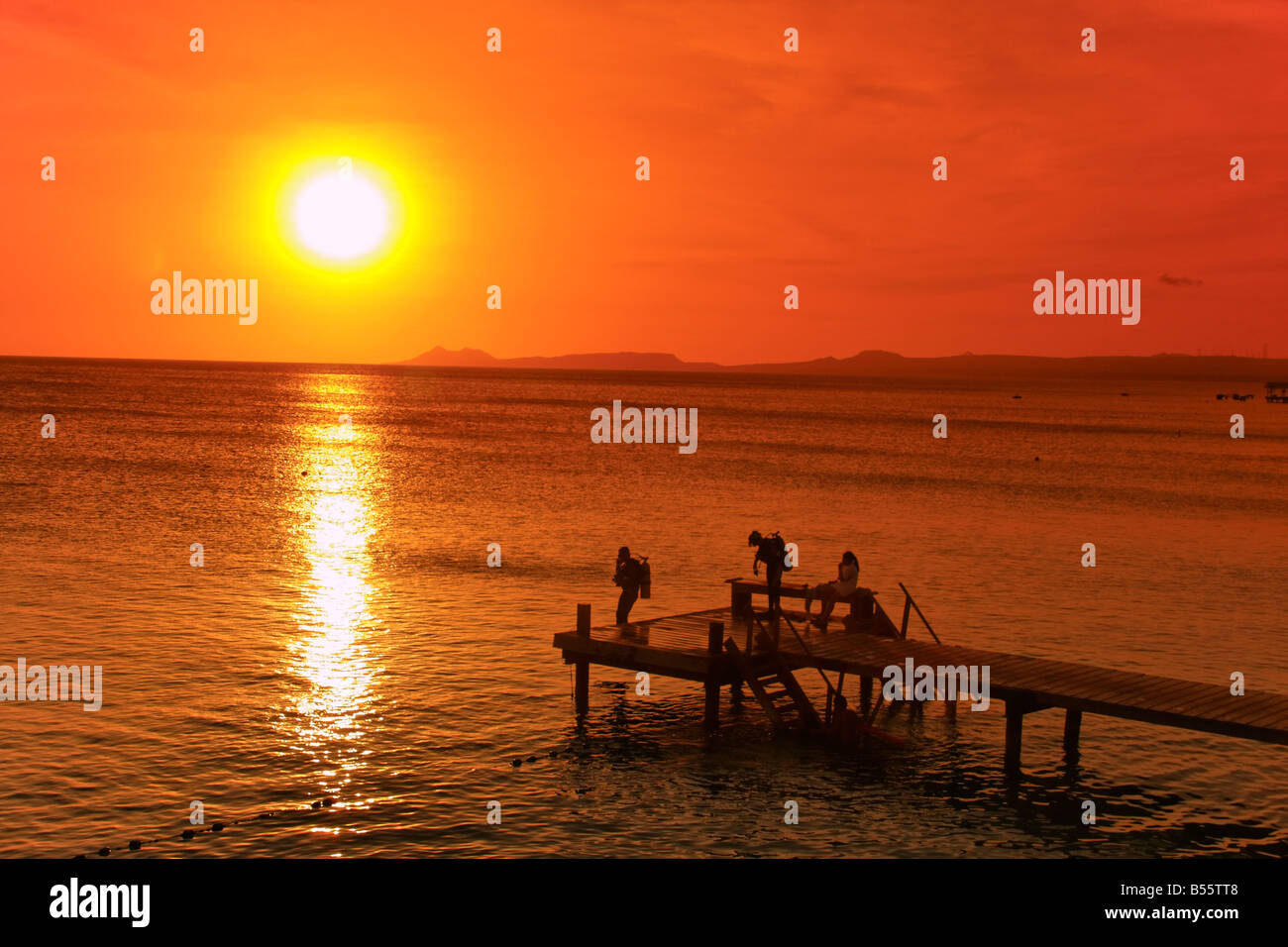 West Indies Bonaire sunset pier diver near Captain Don s Habitat diving resort Stock Photo