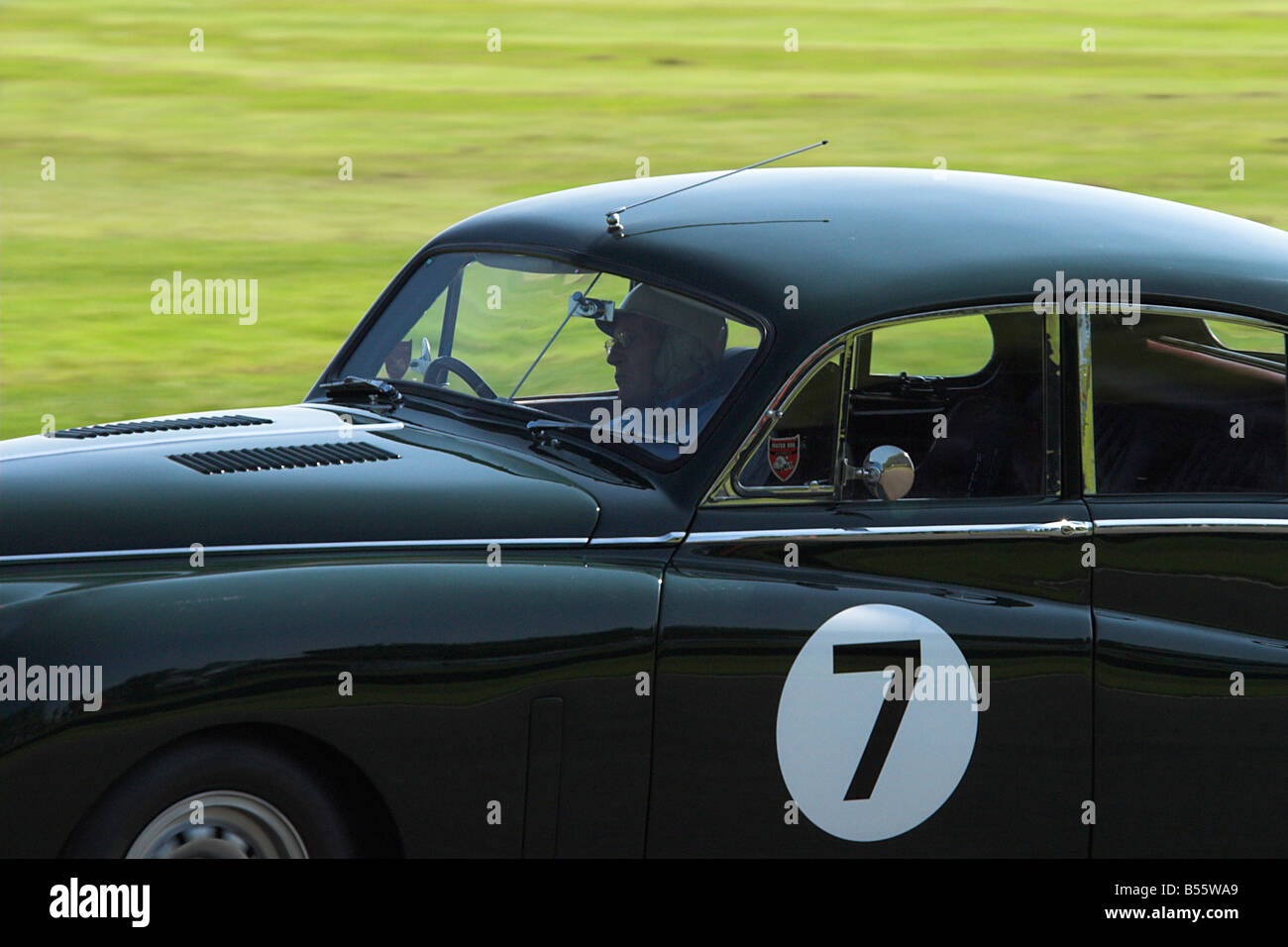 Sir Stirling Moss Racing a Jaguar Mk VII Racing at the Goodwood Revival Stock Photo