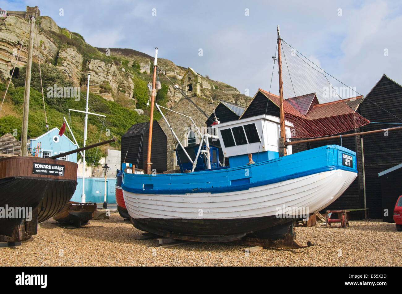 Hastings, East Sussex, England, UK. Fishing boats among Shops