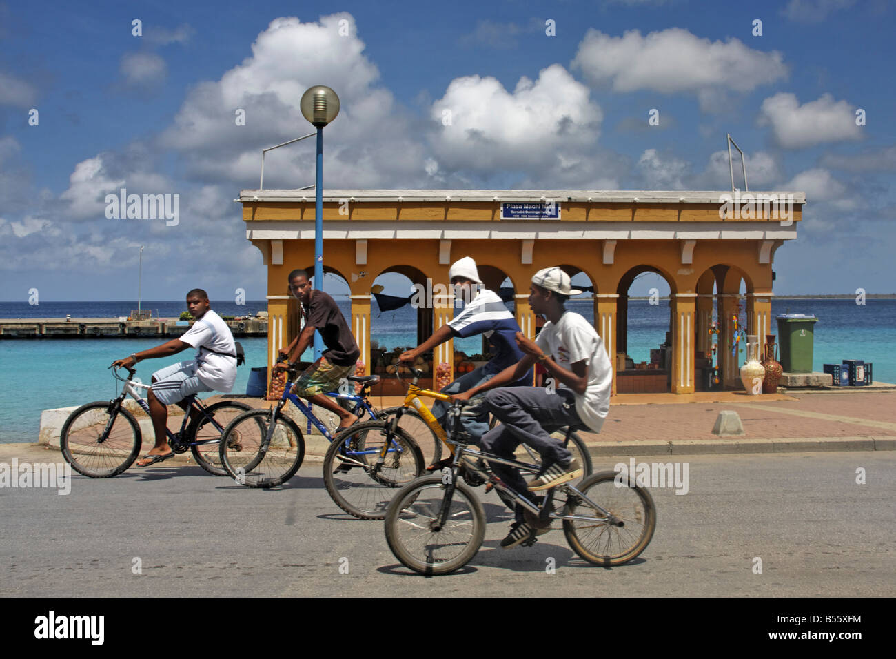 West Indies Bonaire Kralendijk local kids with bicycles Promenade Stock Photo