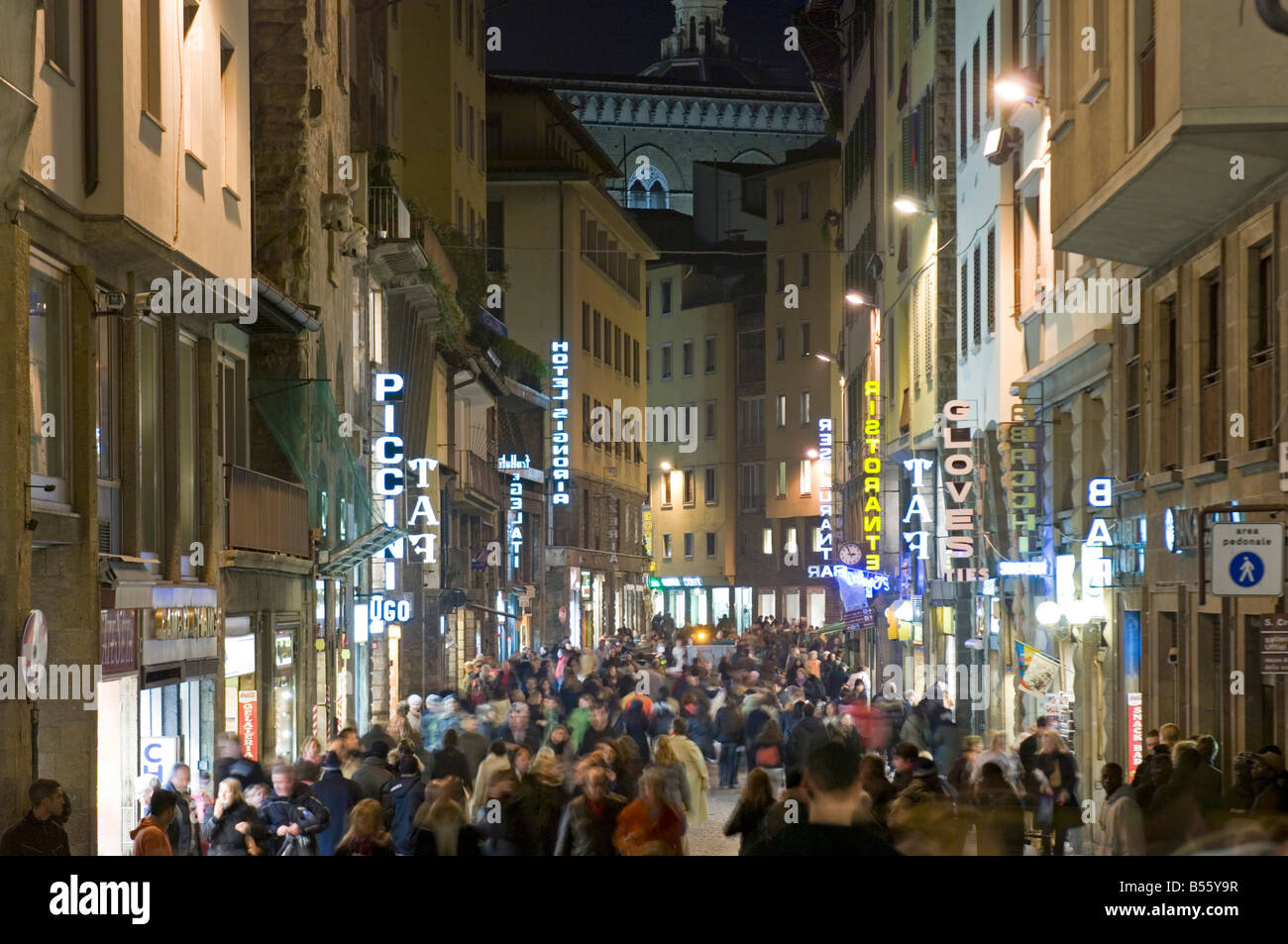 A view of shoppers and people walking along Via Por Santa Maria - compressed perspective and slow shutter speed for motion blur. Stock Photo
