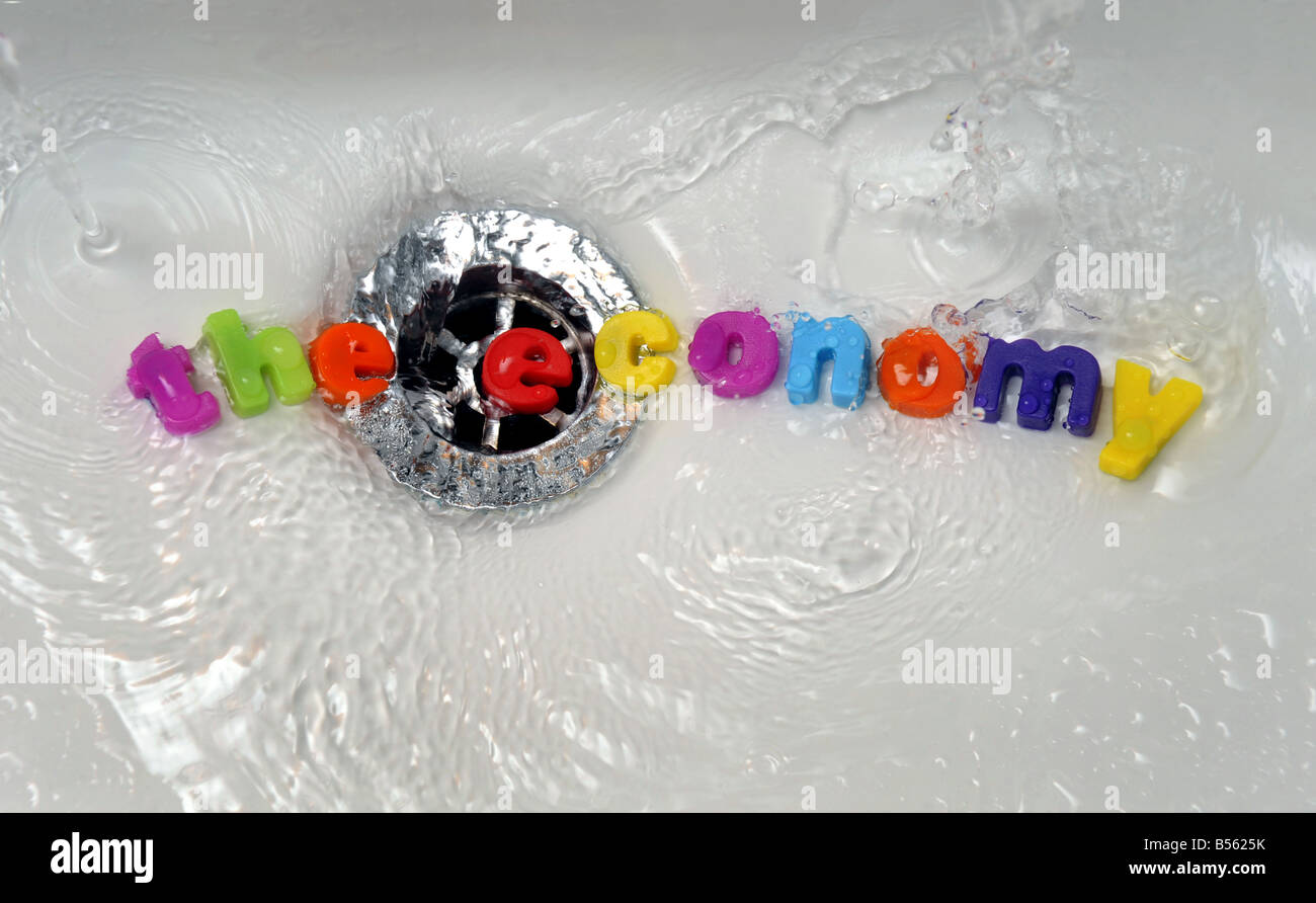 'THE ECONOMY' GOING DOWN  THE DRAIN/PLUGHOLE....WORDS SPELLING 'THE  ECONOMY' ARE WASHED DOWN A PLUGHOLE BY WATER. Stock Photo