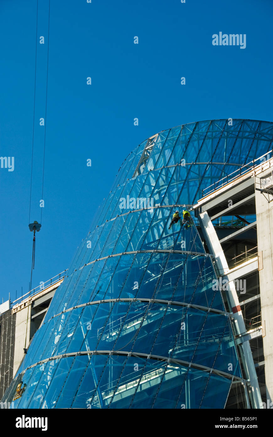 Teams of construction engineers working on the glazing of the new