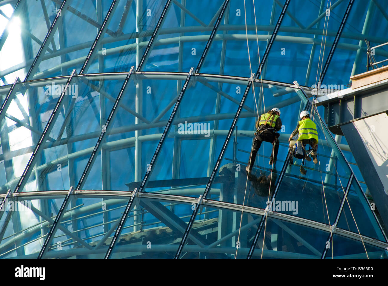 Teams of construction engineers working on the glazing of the new