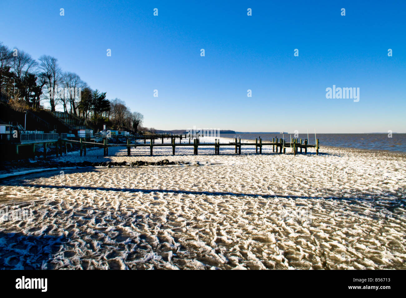 Overlooking a few dock and piers of the upper Chesapeake Bay.  Freezing temperatures set in overnight forming ice in the water. Stock Photo